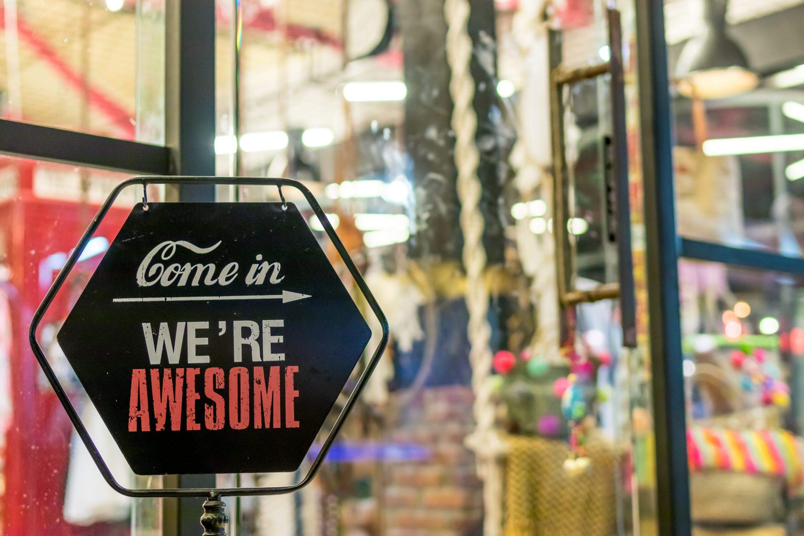 “Come In, We’re Awesome” storefront sign representing inviting small business advertising